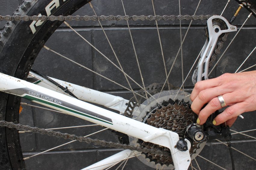 Lift the derailleur up and back and you create space.